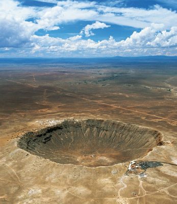 Aerial view of Meteor Crater, a ¾ mile (1.2 kilometers) wide hole in the Arizona desert formed approximately 50,000 years ago by the impact of a small iron-rich asteroid traveling at speeds exceeding 6 miles (10 kilometers) per second