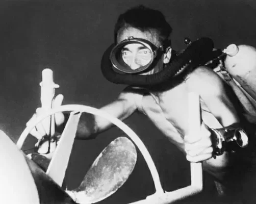 A 1955 photograph of French oceanographer and explorer Jacques Cousteau, utilizing his Nautilus underwater propulsion device.