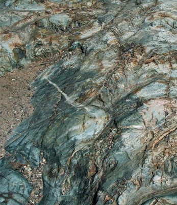 This image shows a glacially smoothed section of Archean greenstone, originally basaltic pillow lava, from the Upper Peninsula of Michigan, spanning approximately 10 feet (3 meters) across.