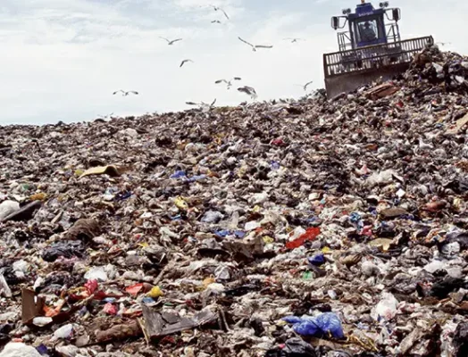 A 1995 photograph depicting the disposal of trash at the Fresh Kills landfill in Staten Island, New York. This landfill, operational from 1948 to 2001, was formerly the world's largest.