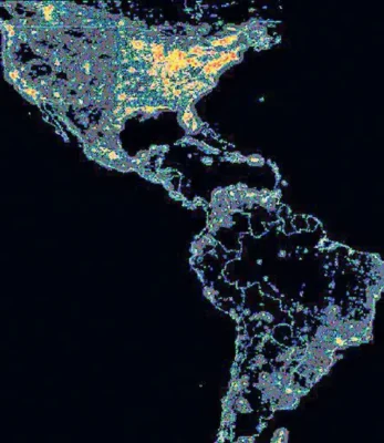 This map illustrates artificial night-sky brightness in a portion of the Western Hemisphere, sourced from the US Defense Meteorological Satellite Program. The reddest areas, predominantly in the eastern and western United States, indicate locations where light pollution increases nighttime brightness to nearly ten times that of the natural sky.