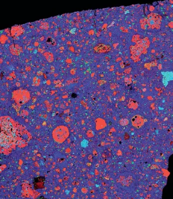 This X-ray image reveals the presence of magnesium (red), calcium (green), and aluminum (blue) within the Murchison meteorite, an exceedingly ancient carbonaceous chondrite that dates back more than 4.55 billion years. This meteorite contains primitive minerals that condensed from the solar nebula, as well as water and intricate organic molecules. Among its remarkable contents are over 70 types of amino acids.