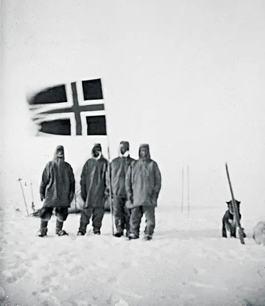 Photograph of Roald Amundsen (right) and three other members of his team planting the Norwegian flag at the South Pole on December 17, 1911.