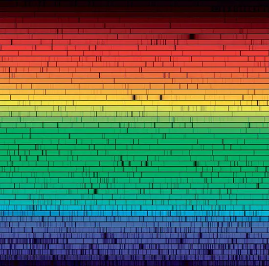 A sequence of high-resolution visible-light spectra of the Sun displaying Fraunhofer lines, captured at the McMath-Pierce Solar Facility at Kitt Peak National Observatory in Arizona. The wavelengths progress from the bottom to the top in each row, with violet at the bottom and red at the top.