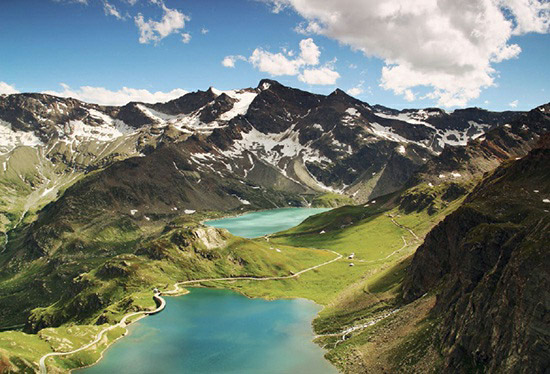 A summertime view of the geologically young and rugged Italian Alps, towering above stunning high mountain lakes