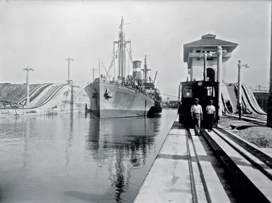 A 1914 photograph of the USS Santa Clara transiting through the Miraflores locks of the Panama Canal.