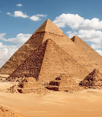 The great pyramids of Giza, used as burial sites for pharaohs and serving as astronomical markers pointing to the presumed gateway to the heavens at the north celestial pole. These structures held the title of the world's largest human-made constructions for nearly 4,000 years