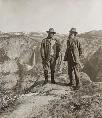 A 1903 photograph featuring American conservationist John Muir, founder of the Sierra Club, alongside US President Theodore Roosevelt on Glacier Point in Yosemite Valley, California.