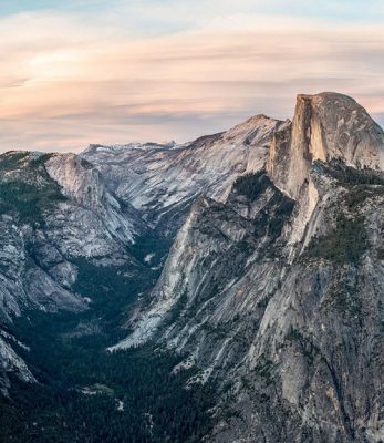 A breathtaking view of Yosemite Valley from Glacier Point, featuring the iconic Half Dome mountain as the tallest peak.