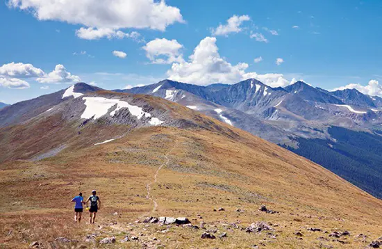 Scenic trails winding through the high-altitude tundra environment of the Rocky Mountains, Colorado.