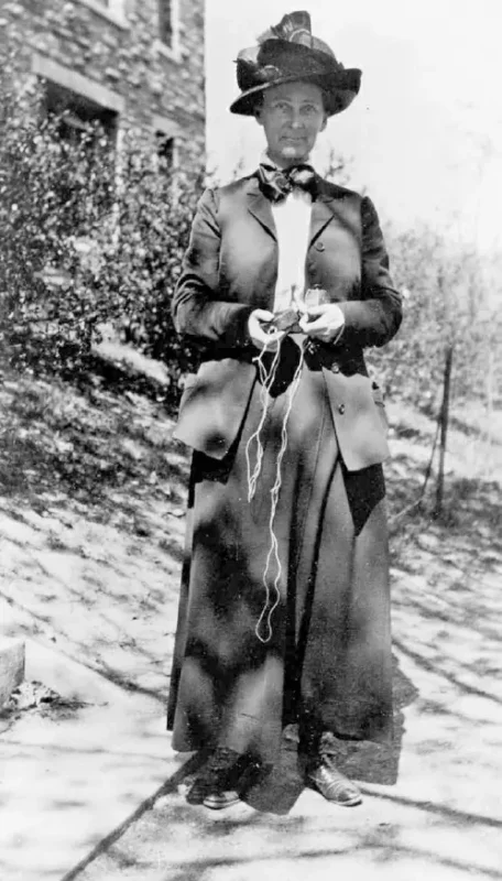 An undated archival photo from Smith College showing geologist Florence Bascom holding her geologic compass.