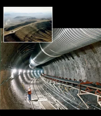 Main image: A section of the initial exploratory tunnel excavated beneath Yucca Mountain during the preliminary assessment studies of the site as a potential long-term repository for nuclear waste. Inset: A 2006 photograph of the summit of Yucca Mountain in southern Nevada.